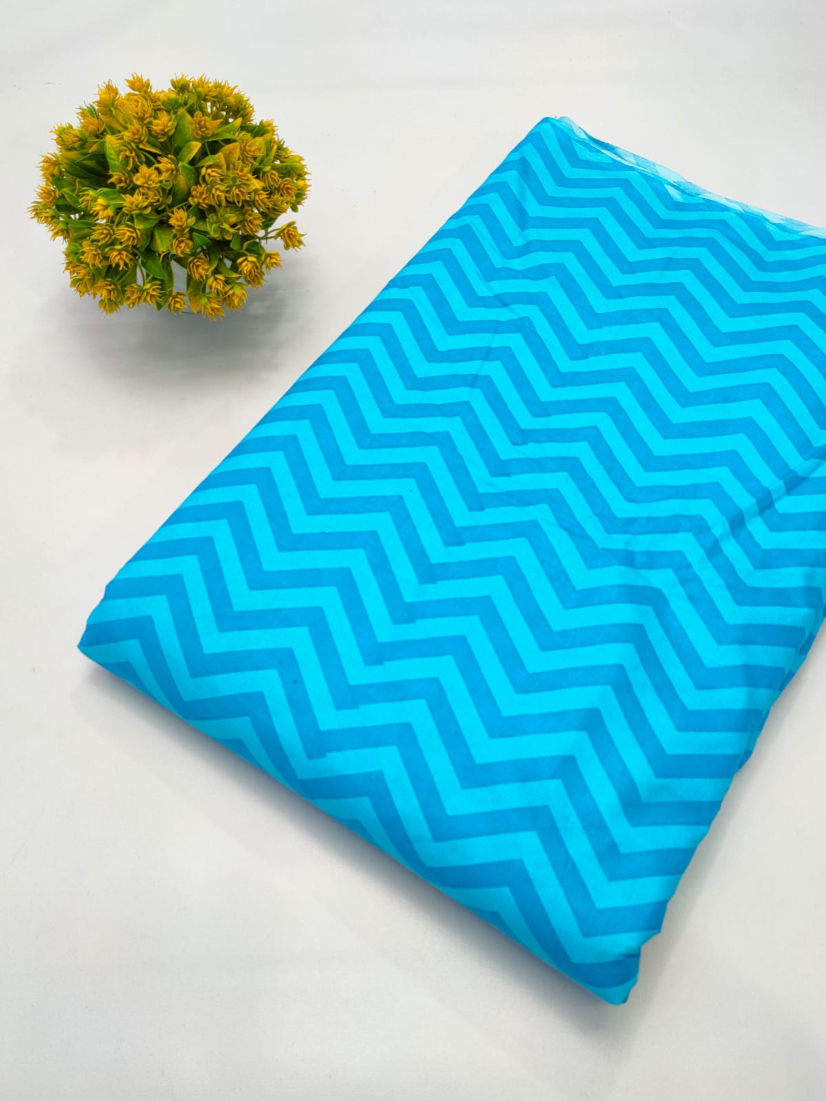Close-up of Turquoise Zigzag Screen Print Pure Cotton Fabric from Tulsi Prints