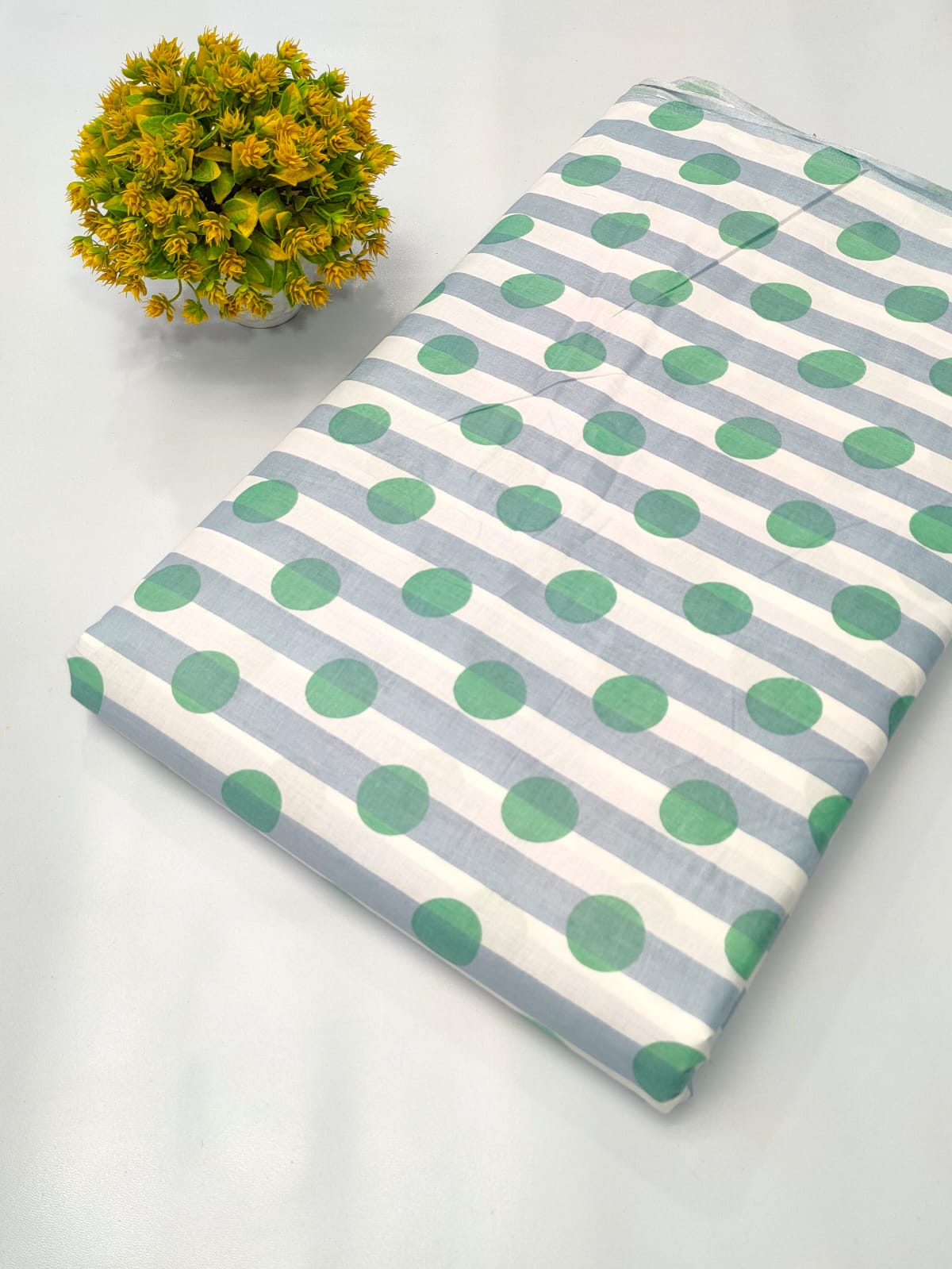 Close-up of Green Polka Dot Screen Print Pure Cotton Fabric from Tulsi Prints