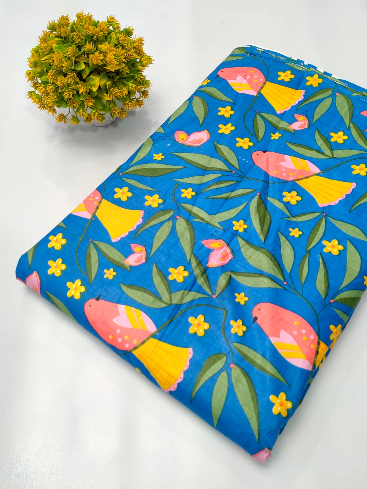 Close-up of blue floral bird motif screen print pure cotton fabric from Tulsi Prints