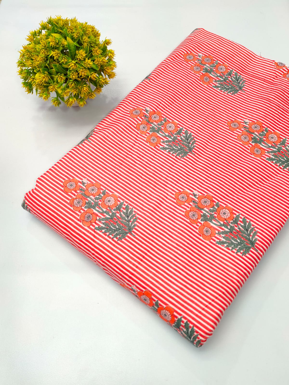 Close-up of red floral striped screen print pure cotton fabric from Tulsi Prints